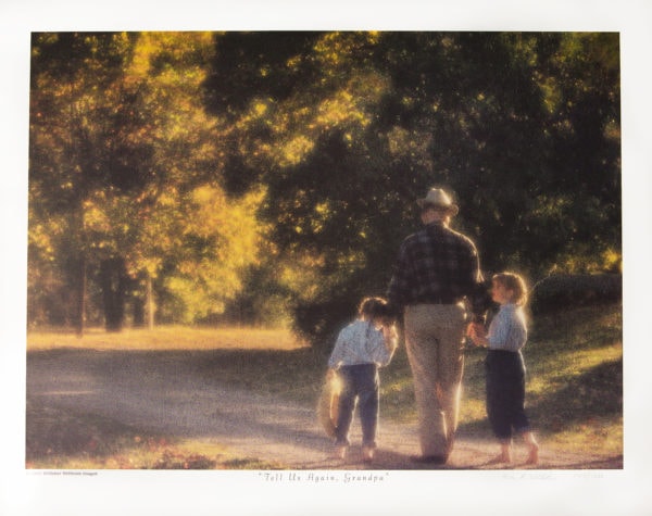 Grandfather and granddaughters walking down a country path into the sunlit trees.